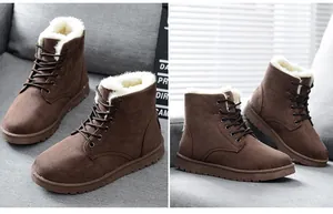 Detail view of brown suede winter boots with thick white faux fur lining and laces