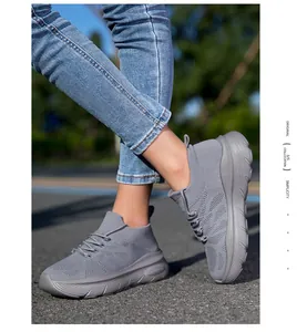 Comfortable grey breathable knit fly-woven sock sneakers in a stylish outdoor setting