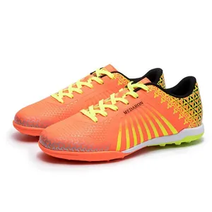Men's and youth soccer shoes with bright orange synthetic upper and TF turf studs
