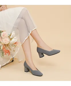 Close-up of grey ribbed block heel pumps with square toe and V-neck design.
