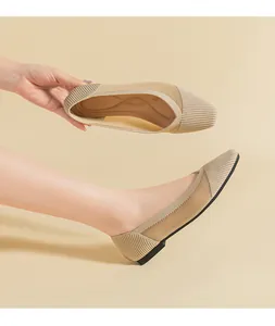 Macro view of beige mesh knit flat shoes showing detailed breathable texture and design.