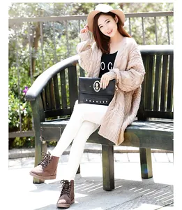 Asian model wearing warm brown winter boots with lace-up design sitting on a bench