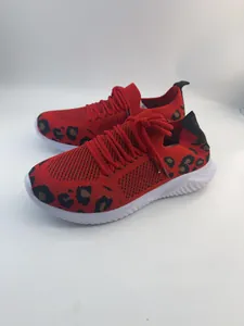 Detail view of red fly-knit walking sneakers with stylish leopard print pattern