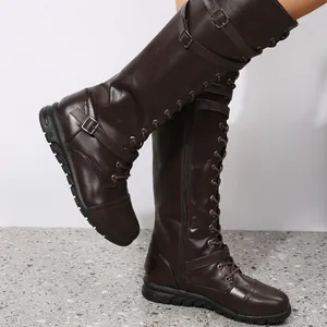 Detail shot of women's dark brown high boots featuring round toe and multiple buckle straps