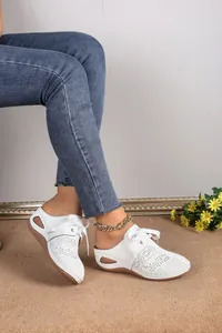 Comfortable white hollow-out closed-toe mule sandals featuring lace-up detail and wedge heel