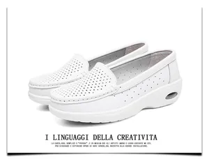 Close-up of white perforated leather nursing shoes with wedge air cushion sole