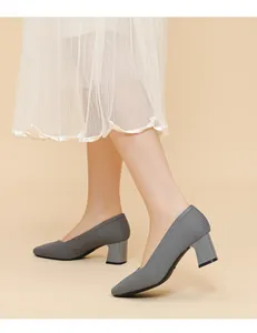 Detailed side view of elegant grey ribbed block heel pumps with a stylish V-neck design.