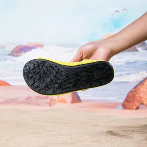 Bright yellow non-slip water shoes for beach and swimming showing durable sole detail