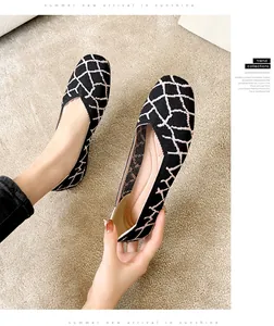 Detail showing black and beige woven pattern on these square toe flat grandma shoes