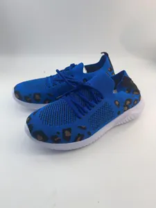 Detail view of blue women's walking shoes featuring leopard print and knit mesh