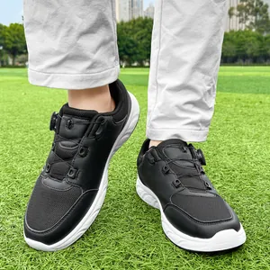 Detailed view of men's black golf shoes with rotating dial lace on green grass