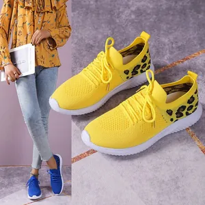 Detailed view of yellow mesh leopard print sneakers with comfortable white sole