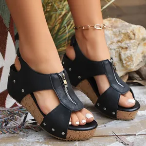 Detailed view of black wedge sandals for women featuring front zipper and stud accents