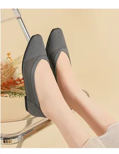 Detailed macro view of grey woven mesh ballet flats with square toe on model's feet