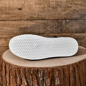 Gedetailleerde weergave van de witte gegolfde antislipzool van een casual canvas sneaker