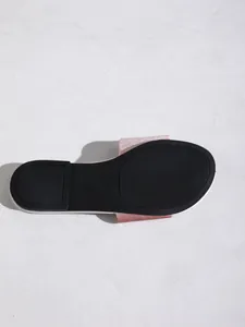 Bottom view of pink glitter slippers showing the black non-slip rubber sole detail