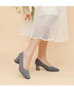 Close-up showing the textured ribbed knit and V-neck design of these grey pumps.