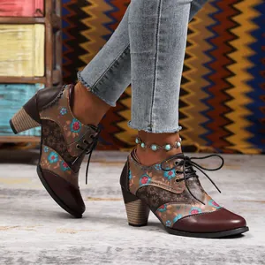Detailed view of vintage bohemian floral print lace-up ankle boots with chunky heel.
