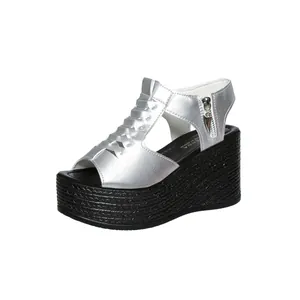 Detailed view of silver wedge platform sandals featuring a metallic peep-toe design