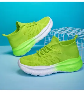 Close-up of neon green fly-knit sock sneakers featuring thick soles and gradient midsoles