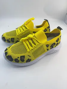 Close-up detail of yellow leopard print breathable knit walking shoes for women's casual wear.