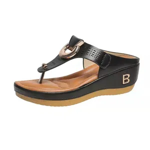 Black wedge thong sandal featuring gold circular ornament and letter B heel detail