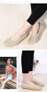 Detail view of beige cowhide loafers on Asian model with soft rubber sole and flat design