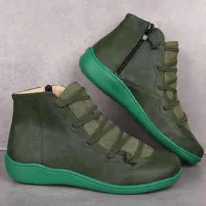 Detailed side view of green casual women's ankle boots with vibrant flat soles.