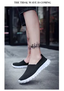 Detailed view of breathable black woven slip-on loafers with thick white soles for casual wear