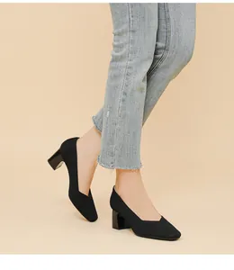 Detailed view of elegant black ribbed fabric block heel pumps with V-cut square toe