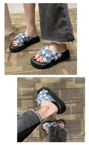 Detailed view showing the blue checkered denim crossover straps on thick platform sandals