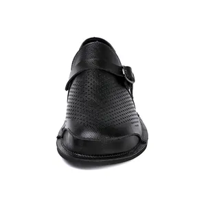 Front detail of vintage black leather shoes with wide toe box and perforated design