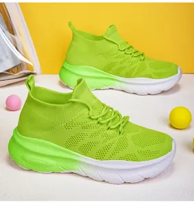 Vibrant lime green knit sock sneakers with thick white soles for a trendy look.