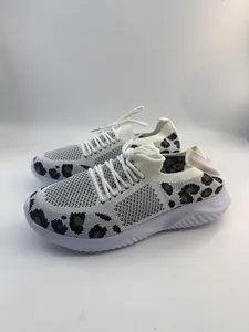 Detailed side view of white breathable fly-knit walking shoes with leopard print