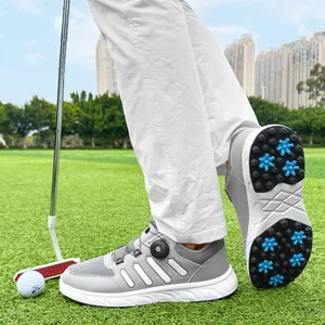 Detail view of men's lightweight grey golf shoes with spikes and rotating buckle