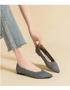 Close-up of elegant grey pointed toe knitted mesh flat shoes with breathable design