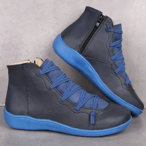 Side view of casual black women's ankle boots with vibrant blue soles and cross laces.