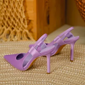 Close-up of lavender satin pointed-toe slingback high heels on a woven rug