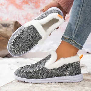 Close-up of women's winter warm flat shoes with white fur lining and grey knit upper texture.