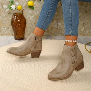 Detailed view of women's taupe ankle boots with floral cut-out and pointed toe