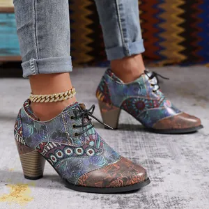 Detailed view of bohemian style chunky heel ankle boots with colorful ethnic patterns