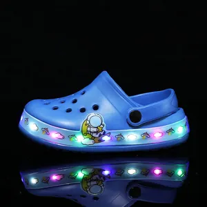 Blue children's LED light-up clogs with astronaut theme and colorful glowing soles