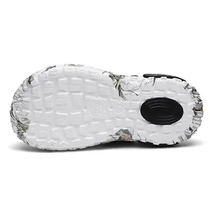 Bottom view of white breathable clogs featuring a non-slip square lug sole pattern and size mark