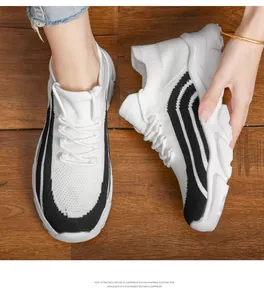 Detailed view of breathable white knitted women's sneakers with thick lightweight EVA sole