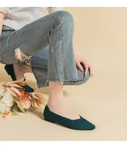 Detail of dark green hollow-knit pointed-toe flats with breathable mesh material