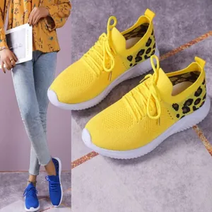 Detail showing mesh texture and leopard print on yellow casual women's sneakers