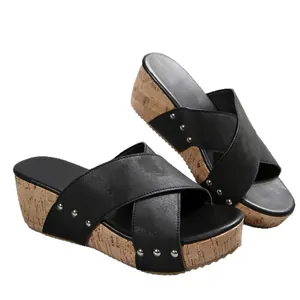 Elegant black criss-cross wedge sandals for women with rivet details and cork platform sole