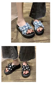 Detail view of checkerboard platform sandals with cross straps in blue and black.