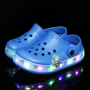 Blue children's LED light-up clogs with cute space astronaut pattern for summer beach.