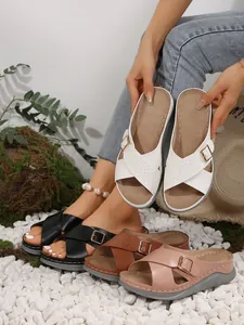 Detailed view of women's wedge sandals with cross-strap design in multiple colors